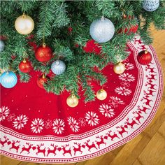 a christmas tree skirt with ornaments on it