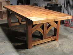 a large wooden table sitting in a garage