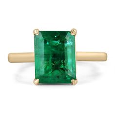 an emerald ring set in yellow gold