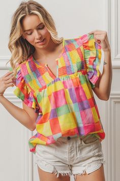 Woven Smocked Detail Top Experience a burst of color with this printed woven top featuring smocked detailing and ruffled sleeves. The V neck adds a touch of style to this playful and fun piece. Casual Smocked Top With Flutter Sleeves, Bohemian Smocked Short Sleeve Top With Ruffles, Bohemian Smocked Top With Ruffles And Short Sleeves, Summer Ruffle Sleeve Blouse With Smocked Cuffs, Summer Blouse With Smocked Ruffle Sleeves, Summer Blouse With Smocked Cuffs And Ruffle Sleeves, Multicolor Smocked Top With Smocked Cuffs For Summer, Summer Multicolor Smocked Top With Smocked Cuffs, Trendy Smocked Top With Ruffles For Spring