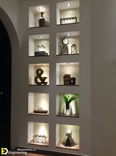 the shelves are filled with various items and lights on them, including vases and clocks