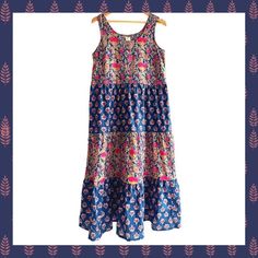 Navy Floral - Hand Block printed women's sleeveless sundress.  Extra soft cotton and extremely comfortable fit and texture.  Perfect for; vacation, a day at the beach, picnic, farmers market, to run errands, a weekend brunch, or dress it up with a cardigan or dress topper for a stylish dress for any occasion. Description: Three-tiered women's dress with swing shape and side seam pockets. Flattering for most body types. Lightweight breathable 100% cotton. *  Care Instructions: Hand wash *  Fabric: 100% cotton *  Season: Spring/Summer *  Weight: 10.56 oz (299.37 g) *  Dimensions: 27 in (68.6 cm) Eco-friendly information *  Packaging: Recyclable *  Product Materials: Plastic-free *  Production: Fair trade Sleeveless Cotton Sundress For Beach Season, Multicolor Cotton Sundress For Beach Season, Cotton Sleeveless Dress For Beach Vacation, Cotton Sleeveless Maxi Dress For Beach Season, Sleeveless Cotton Maxi Dress For Beach Season, Sleeveless Cotton Maxi Dress For Summer, Patterned Sleeveless Printed Dress, Beach Season Cotton Maxi Dress With Floral Print, Cotton Floral Print Maxi Dress For Beach Season