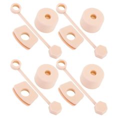 six pieces of pink plastic with white handles