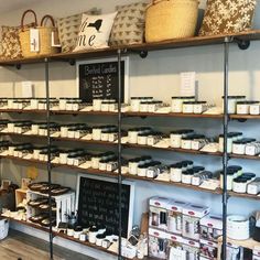 the inside of a store with shelves full of items and baskets on top of them