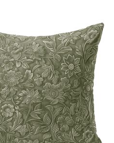 a green pillow with flowers on it