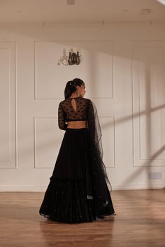 Black fully embroidered choli with net sleeves paired up with georgette layered lehenga and black net dupatta. No. of pieces in a set: 3 Color: Black Fabric Composition: Net,georgette, opada silk Lining Material: Shantoon Closure used: Side zip in both choli and lehenga Dress Length : Full Silhouette: Gathered Neck type : Round neckline Sleeve Length: full Sleeves Waistline: High waist Prints/ Pattterns : Plain Delivery Time: 20-25 days Black Lehenga Look, Black Choli, Layered Lehenga, Net Sleeves, Lehenga Dress, Black Lehenga, Net Dupatta, Full Sleeves, Full Sleeve