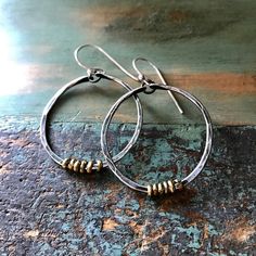 "These thick hammered hoops are a great every day size. Made of 14 gauge sterling wire that I've forged, oxidized and polished to a matte finish. I've added some tiny brass Ethiopian heishi beads for a mixed metal contrast. They hang from sterling earwires. 1 1/2\" diameter (2nd photo, small pair)" Small Silver Hoop Earrings, Large Silver Hoop Earrings, Burlington Vt, Brass Hoop Earrings, Brass Hoops, Small Jewelry Box, Feather Necklaces, Heishi Beads, Small Jewelry