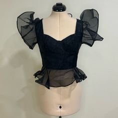 2 Words: Statement Piece! This Top Is So Versatile And Can Bring The Drama To Any Look! Nwt, No Major Flaws Noted Some Minor Frays Here And There Size L Has One Miniscule Snag/Gather On The Back Sheer Section, Pictured Can Either Stop Zipper A Little Early To Utilize Hook & Eye Closure Or Just Zip All The Way Without Using The Hook & Eye Closure, Pictured If Steamed, The Sheer Material’s Volume Will Be A Little Less Dramatic Cropped Corset Type Bodice Sweetheart Neckline Sheer Peplum Detail Tank Fitted Black Blouse For Summer, Black Puff Sleeve Top For Formal Occasions, Feminine Black Tops For Party, Feminine Black Top For Party, Feminine Black Party Top, Black Sheer Corset For Party, Fitted Padded Blouse For Evening, Fitted Ruffle Blouse For Date Night, Feminine Fitted Blouse For Night Out