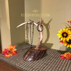 a table topped with a statue of an antelope