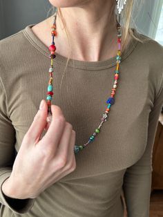 Step into style with our 28-inch Unique Single Strand Boho Beaded Necklace! Handcrafted with love, this piece features sparkling crystal beads, vibrant coral, the standout buffalo white turquoise bear bead, deep blue lapis, warm copper beads, grounding agate, and energizing red jasper. Each material is chosen not just for its beauty, but for the story it tells and the energy it brings. Perfect for any occasion, this necklace adds a touch of bohemian flair and a splash of color to your wardrobe. Multicolor Beaded Bohemian Crystal Necklaces, Bohemian Multicolor Beaded Crystal Necklaces, Artisan Multicolor Beaded Crystal Necklace, Bohemian Faceted Beads For Festival, Bohemian Multicolor Faceted Beads Crystal Necklaces, Bohemian Beaded Czech Glass Crystal Necklaces, Beaded Bohemian Czech Glass Crystal Necklace, Adjustable Multicolor Crystal Necklaces With Large Beads, Bohemian Crystal Necklaces With Spacer Beads As Gift