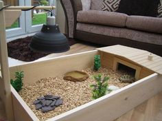 a living room filled with furniture and lots of gravel in the floor next to a couch