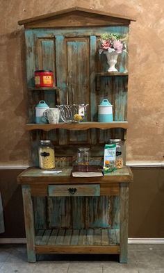 an old wooden hutch with various items on it