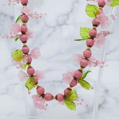 This sweet Mid Century necklace is made of Italian Venetian handblown pink glass flowers and green glass leaves. There are some pieces missing and some leaves are chipped. This necklace measures 19 inches in length. It is in good vintage condition with surface wear. Pink Flower-shaped Necklace With Flower Decoration, Pink Flower Necklace With Flower Decoration, Pink Glass Beaded Necklace For Gift, Pink Glass Necklace With Round Beads, Pink Glass Beaded Necklaces For Gift, Pink Single Strand Glass Necklace, Pink Flower-shaped Glass Jewelry, Pink Flower Glass Jewelry, Pink Glass Beaded Necklaces