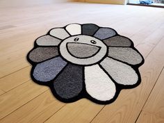 a black and white flower rug on the floor