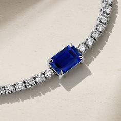 Simple elegance with a modern twist, our Nouveau Tennis Bracelet is strung with a row of twinkling petite diamonds that lead to a captivating emerald cut royal blue sapphire that rest at the center. Everyday luxury is made easy with this captivating bracelet that sparkles from every angle and exudes your strong sense of refined style. Wear it alongside your watch or layer it with a stack of delicate bracelets. Metal: 18kt Gold Sapphire Weight: 1.35 ct. Diamond Weight: 2.95 ct. Measurements: 7.0" length *Please note that the listed ct. weights are approximate and may be subject to slight variations. Luxury Blue Sapphire Tennis Bracelet, Timeless Sapphire Jewelry With Radiant Cut, Emerald Cut Tennis Bracelet With Diamond Accents, Emerald Cut Diamond Accents Tennis Bracelet, Classic Emerald Cut Jubilee Bracelet, Formal Radiant Cut Lab-created Sapphire Jewelry, Luxury Emerald Cut Diamond Bracelet, Elegant Emerald Cut Tennis Bracelet For Anniversary, Elegant Emerald-cut Tennis Bracelet For Anniversary