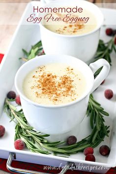 two white cups filled with egg puree and garnished with cinnamon