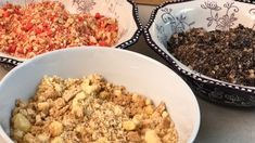 three bowls filled with food sitting on top of a table next to a bowl full of dirt