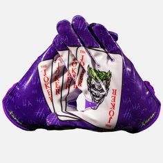 two purple gloves with white and red designs on the front, one has a joker face