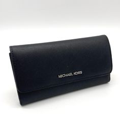 Brand New With Tag Michael Kors Jet Set Travel Item, This Trifold Wallet Features: Color: Black Saffiano Leather Outlet Style Silver Tone Hardware Michael Kors Lettering Logo On Front Trifold Wallet W/ Snap Button Closure Full Length Zippered Pocket W Leather Pull On Back Interior: 1 Window Id, 4 Full Bill Slots, & 17 Credit Card Slots. Mk Signature Logo Fabric And Saffiano Leather Lining 7.5" W 4' H 0.75" D Modern Trifold Wallet For Evening, Modern Evening Trifold Wallet, Elegant Michael Kors Wallets For Daily Use, Elegant Michael Kors Wallets, Black Trifold Wallet For Evening, Elegant Michael Kors Wallets With Card Slots, Elegant Michael Kors Wallet For Travel, Elegant Evening Wallets By Michael Kors, Elegant Michael Kors Evening Wallets