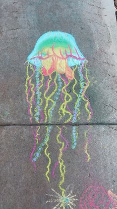 a chalk drawing of a jellyfish on the sidewalk