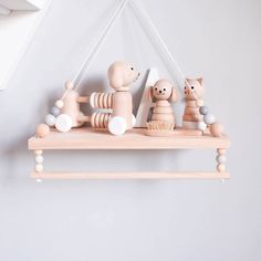 wooden toys are hanging on the wall