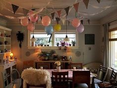 a dining room with balloons hanging from the ceiling