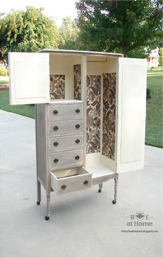 a white cabinet with drawers sitting on top of a sidewalk