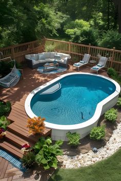 an above ground pool surrounded by wooden decking and seating area with white wicker furniture