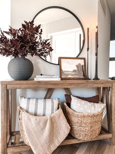 a wooden table topped with baskets filled with pillows