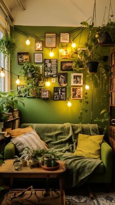 a living room filled with lots of plants and pictures hanging on the wall above it