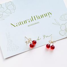 Add a sweet touch to your look with our Lovely Cherry Earrings. Featuring a charming bow design and luscious garnet cherries, these stud earrings are the perfect blend of cute and elegant. Enhance your ensemble with the perfect addition for any occasion, exuding a summer vibe. Dimensions: 1.3cm*1.4cm Materials: Garnet, gold-plated brass, 925 silver needles Affordable Elegant Cherry Earrings, Trendy Cherry Earrings At Affordable Price, Elegant Cherry Drop Earrings, Cherry Color Dangle Earrings, Trendy Cherry-colored Earrings, Cherry Earrings, Bow Design, Summer Vibes, Garnet