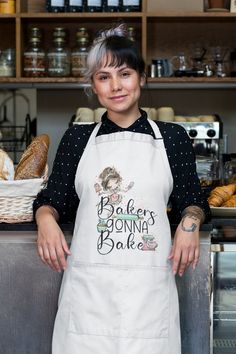 a woman wearing an apron standing in front of some bread