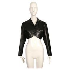 Cropped, jet-black, butter-soft leather jacket with notched collar and curved pockets designed by Azzedine Alaia dating to 1988. Jacket has a very flattering silhouette. Labeled a French size 38. Approximate measurements: shoulder 17", bust 38", hem opening 29", arm length from shoulder seam to cuff 23.5" and overall length at center back (with collar) 16.5". Functioning pockets at bust. Button closure at front and wrists. Extra buttons included. Fully lined. Made in France. Very good condition. Armor Fashion, Azzedine Alaïa, Azzedine Alaia, Black Leather Jacket, Classic Outfits, Notched Collar, Historical Fashion, Jet Black, Elegant Fashion