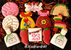 decorated cookies are arranged on a black plate