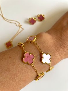 Adorn your wrist in elegance with our exquisite Clover Bracelet. Inspired by the iconic symbol of luck, this bracelet is crafted from the finest gold plating. Elevate any outfit with this sophisticated and exclusive piece, perfect for those with a taste for luxury. Elegant Plated Jewelry As Gift, Elegant Plated Jewelry For Gift, Dainty Gold-tone Bracelets As Gift, Dainty Gold-tone Bracelets For Gift, Pink Bracelet Strap Jewelry For Formal Occasions, Luxury Gold-tone Tarnish Resistant Charm Bracelet, Luxury Bangle Bracelet With Adjustable Chain, Pink Tarnish Resistant Gold Plated Jewelry, Tarnish Resistant Pink Gold Plated Jewelry