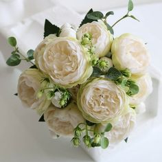 a bouquet of white flowers sitting on top of a table