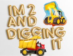 an image of a dump truck with balloons in the shape of trucks and construction equipment