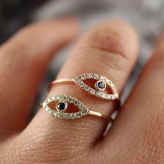 Safeguard yourself against negative energy with this timeless interpretation of the #mystical evil eye motif, a symbol of luck and protection. Cool and dramatic, the #ring combines sparkling pavé-set diamonds with a #blueSapphire center. Ideal for everyday.#eveileyering #evileye Rose Gold Sapphire Ring With Halo, Rose Gold Sapphire Halo Ring, Rose Gold Sapphire Ring With Diamond Halo, 14k Gold Sapphire Ring With Halo Detail, Rose Gold Halo Sapphire Promise Ring, Evil Eye Blue, Birthday Surprises, Eye Motif, Diamond Evil Eye