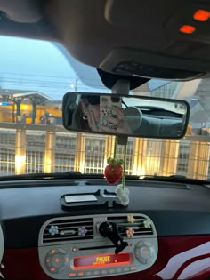 a car dashboard with an electronic device attached to it's dash board in front of a building