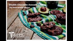 double chocolate avocado cookies on a green and white towel next to an avocado