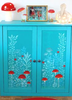 a blue cabinet with mushrooms painted on it