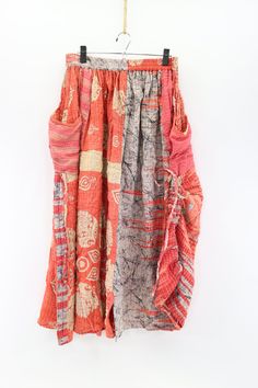 Feel fabulous in this fun skirt! Wear the hem down or cinch it up for a different look. The Festival Maxi Skirt is crafted from vintage kantha embroidered saris and features a comfortable elastic waistband, dropped pouch pockets and cinch-tie detail at the hem. Our beautiful maxi skirt is perfect for dressing up or down. Available in two sizes-(Recommended) S 4-10 L 12-18 Approximately 38” long Care Instructions: Hand wash and line dry for longest life. Disclaimer: The material used in this styl Festival Cotton Skirt With Patchwork, Festival Cotton Skirt With Patchwork Details, Non-stretch Cotton Maxi Skirt With Pockets, Hippie Cotton Patchwork Maxi Skirt, Festival Maxi Skirt, Bohemian Non-stretch Maxi Skirt, Vintage Saris, Vintage Kantha, Handmade Charms