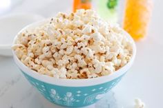 a bowl filled with popcorn sitting on top of a table