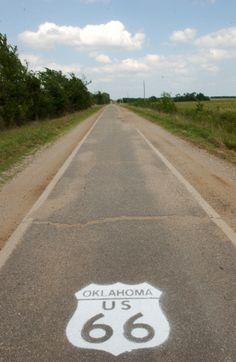 an empty road with a route 66 sign painted on it