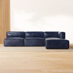 a blue couch sitting on top of a hard wood floor next to a wooden wall