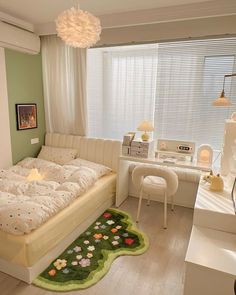 a bed room with a neatly made bed next to a desk and chair in front of a window