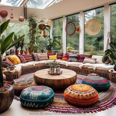 a living room filled with lots of furniture and plants