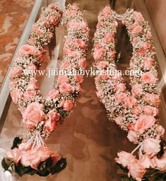 two wreaths made out of flowers on display