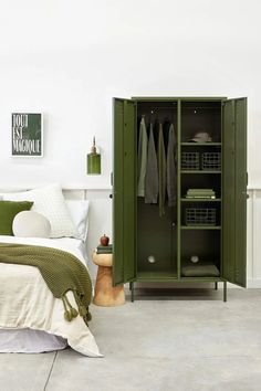 a bedroom with a green locker next to a bed