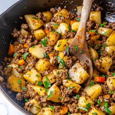 a skillet filled with ground beef and potatoes